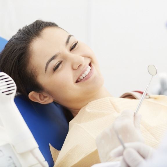 Dental patient smiling during dentistry treatment