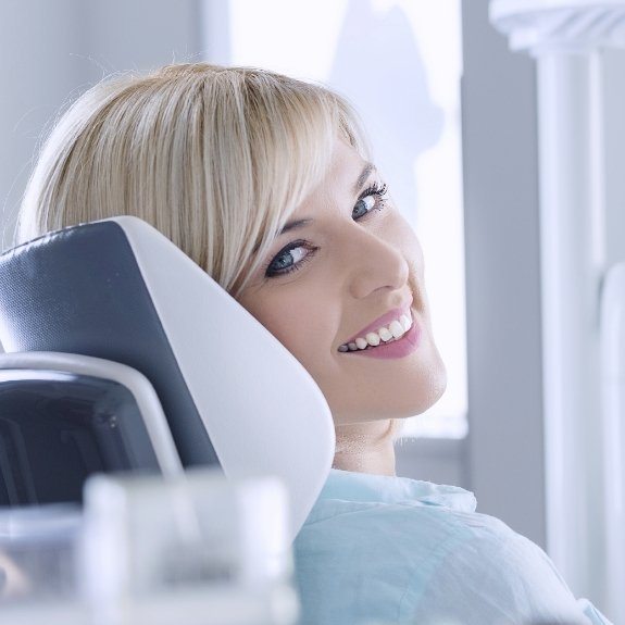 Woman in dental chair smiling