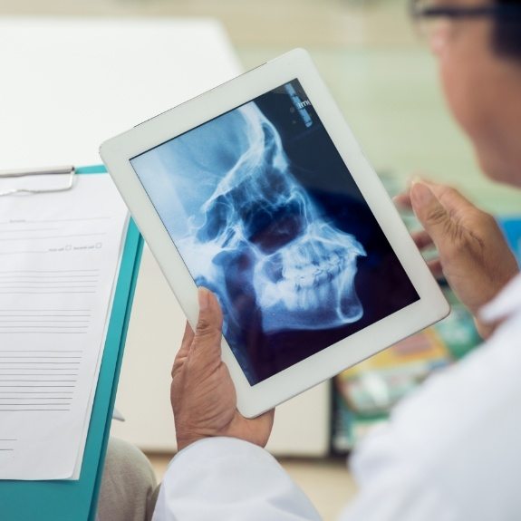 Dentist using x rays to plan T M J therapy