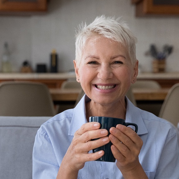 Woman holding a dental bridge