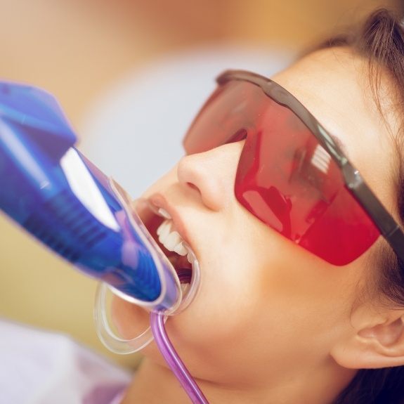 Dental patient receiving teeth whitening treatment