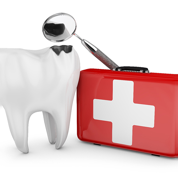 Broken tooth next to a first aid kit