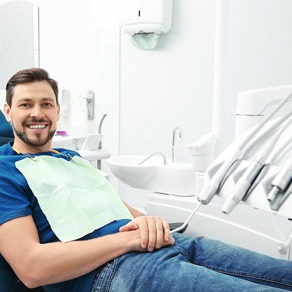 Happy dental patient relaxing in treatment chair