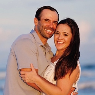 Tulsa dentist and his wife smiling together outdoors