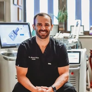 Doctor O'Brien smiling while sitting in Tulsa dental office