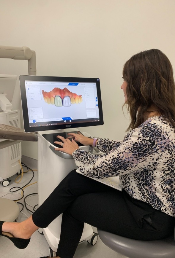 Tulsa dental team member looking at digital impressions of teeth on computer screen
