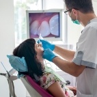 Dentist capturing images of a patient's mouth with intraoral camera