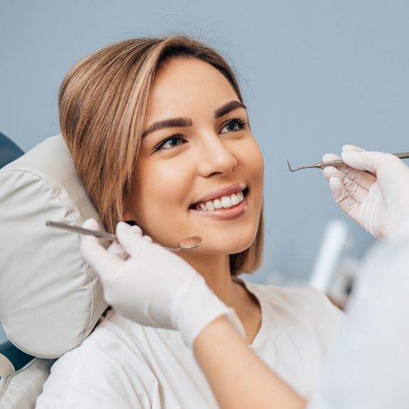 Woman receiving dental checkup and teeth cleaning