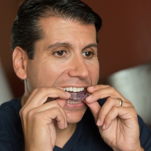 Dental patient placing a nightguard for bruxism