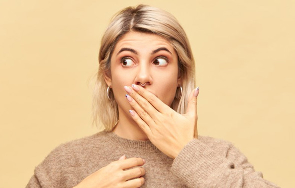 Woman covering her mouth with her hand