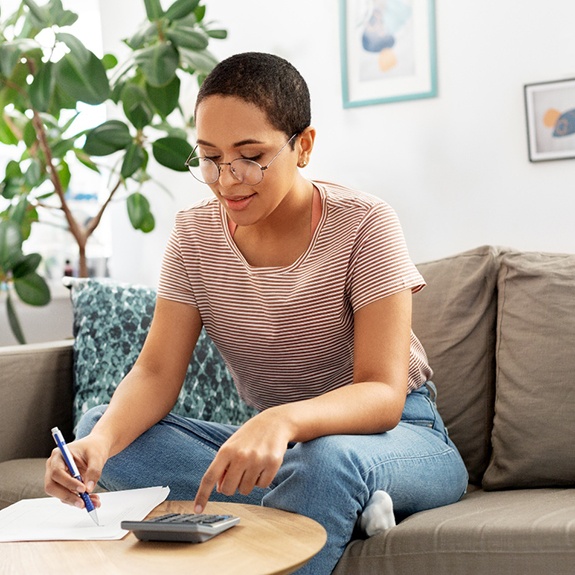 a woman calculating the cost of veneers 